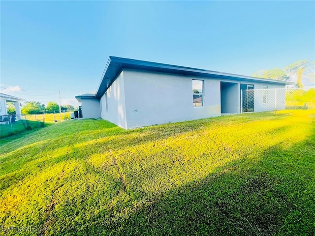 view of property exterior featuring a lawn