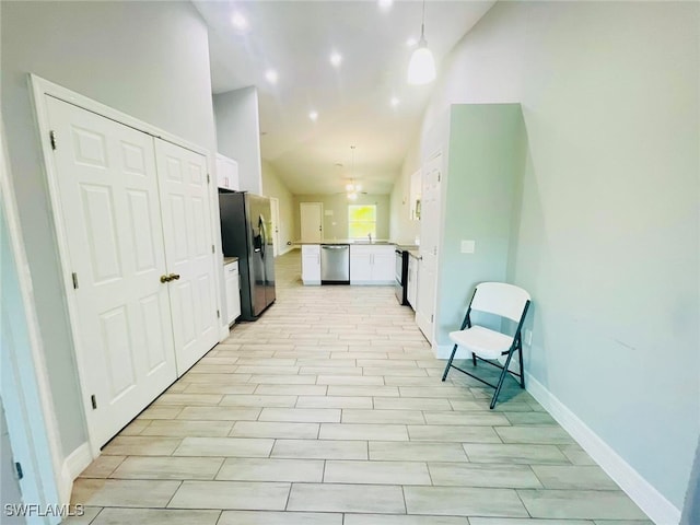 corridor featuring vaulted ceiling