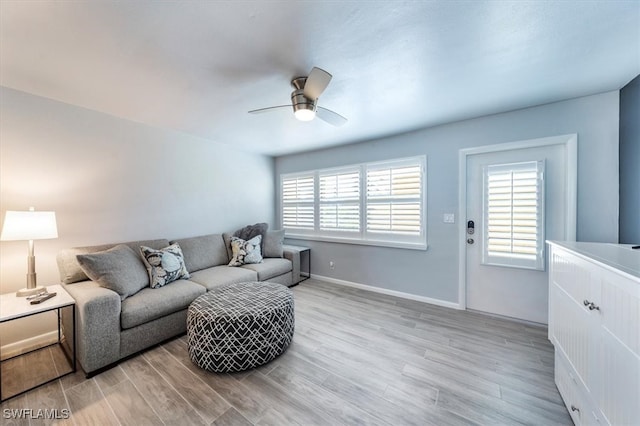 living room with ceiling fan and light hardwood / wood-style flooring