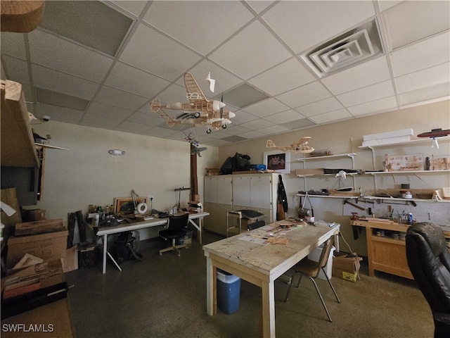 dining room featuring a paneled ceiling and a workshop area