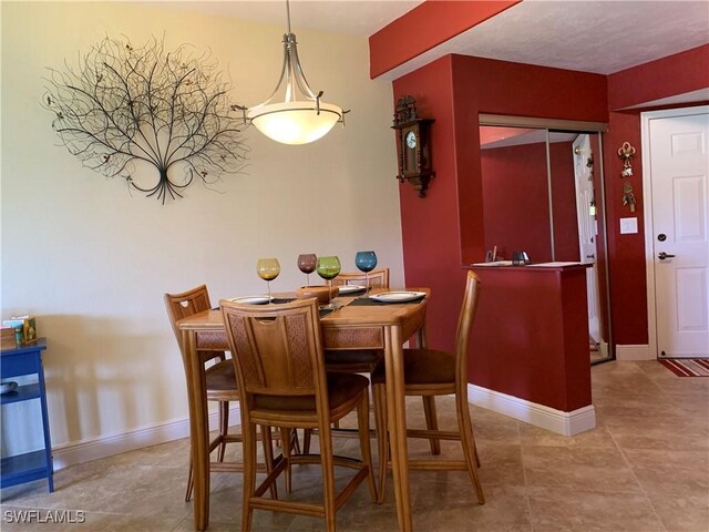 13331 Medinah Cir W Unit 1, Fort Myers, FL 33907 - dining space featuring baseboards and tile patterned flooring