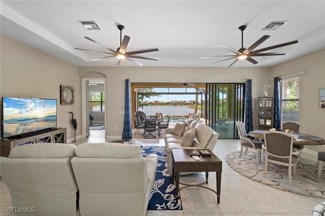 tiled living room featuring ceiling fan