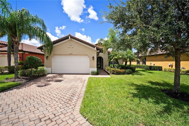 mediterranean / spanish-style home with a garage and a front yard