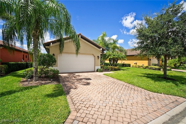 view of front of house with a garage and a front lawn