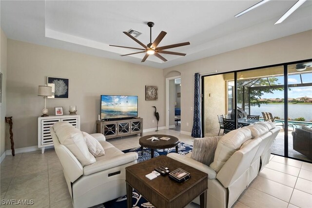 tiled living room featuring ceiling fan