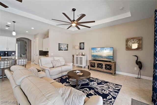 tiled living room with ceiling fan