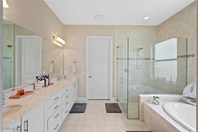 bathroom featuring shower with separate bathtub, tile patterned floors, and vanity