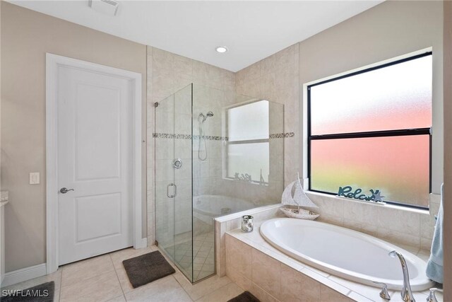 bathroom with tile patterned flooring and separate shower and tub