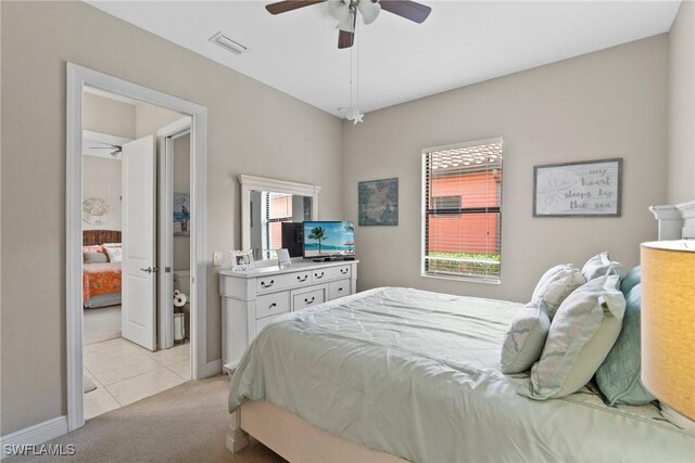 bedroom with multiple windows, light carpet, and ceiling fan