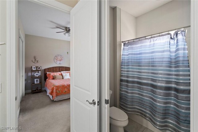 bathroom featuring walk in shower and toilet