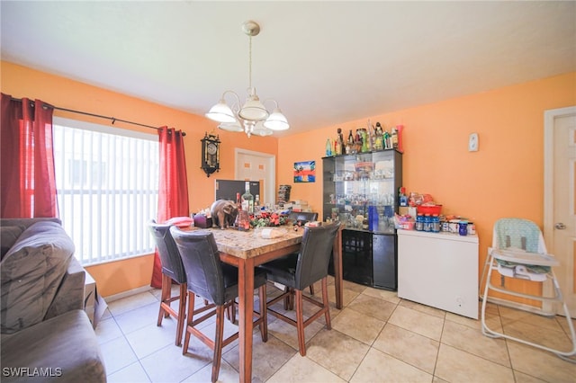 dining space featuring light tile patterned floors and a chandelier