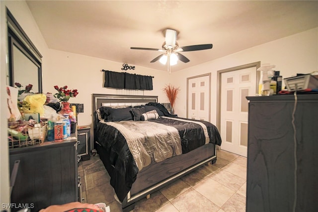 bedroom featuring light tile patterned flooring and ceiling fan