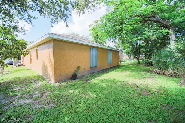 view of property exterior with a yard