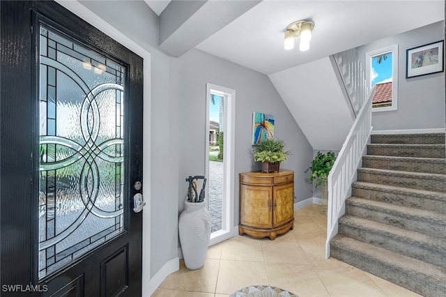 foyer featuring a healthy amount of sunlight and light tile patterned flooring