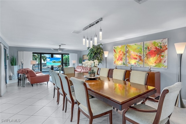 dining room featuring crown molding, ceiling fan, and light tile patterned flooring