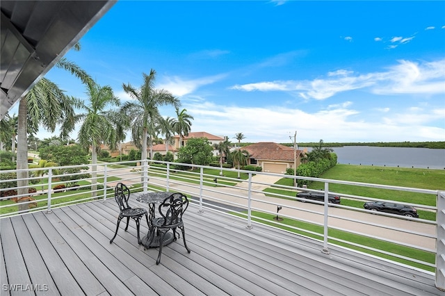 wooden deck featuring a water view and a yard