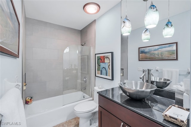 full bathroom featuring tiled shower / bath, vanity, toilet, and tile patterned flooring