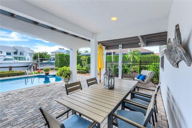 view of patio / terrace with a fenced in pool