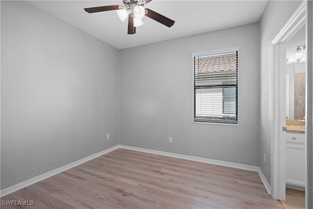 spare room with light hardwood / wood-style flooring and ceiling fan