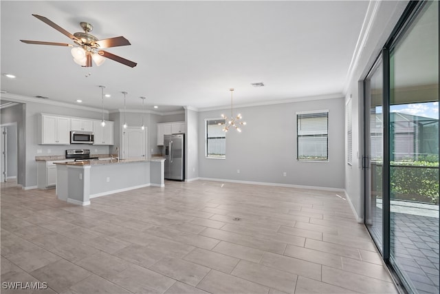 unfurnished living room featuring ceiling fan with notable chandelier and ornamental molding