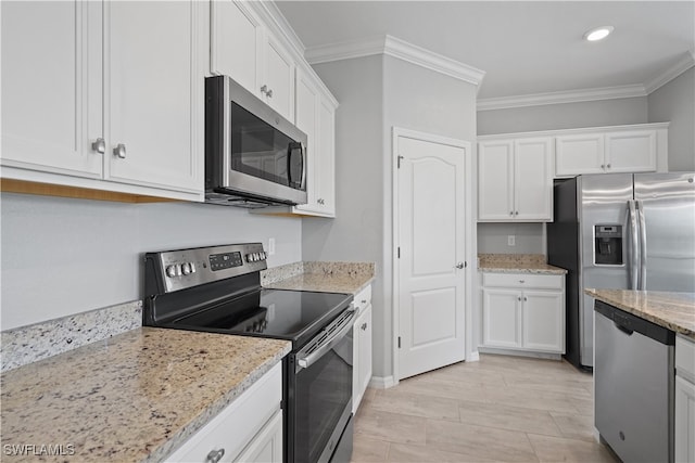 kitchen featuring crown molding, white cabinetry, stainless steel appliances, light stone countertops, and light hardwood / wood-style floors