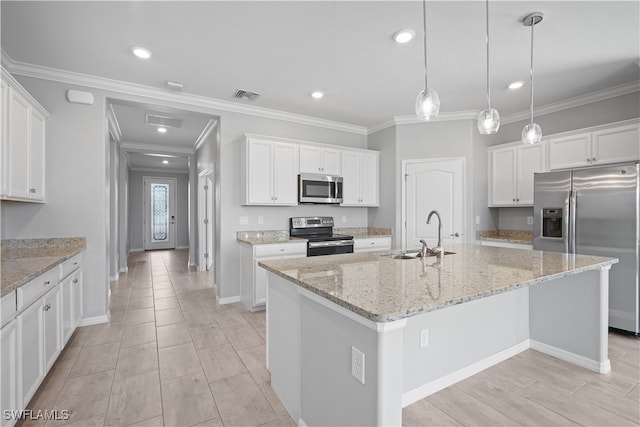 kitchen featuring white cabinets, stainless steel appliances, an island with sink, and sink