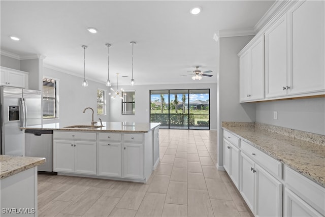 kitchen with decorative light fixtures, stainless steel appliances, white cabinetry, sink, and ceiling fan