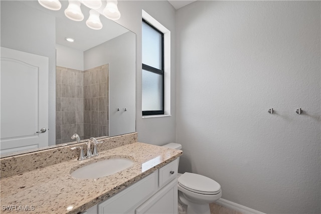 bathroom featuring vanity, toilet, and plenty of natural light