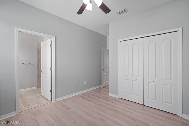 unfurnished bedroom with ceiling fan, a closet, and light wood-type flooring