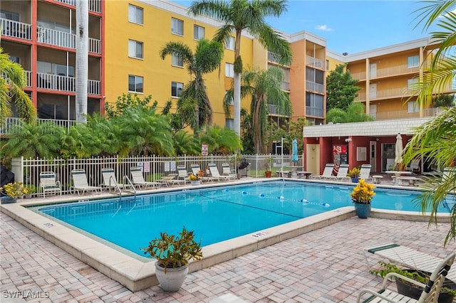 pool with fence and a patio