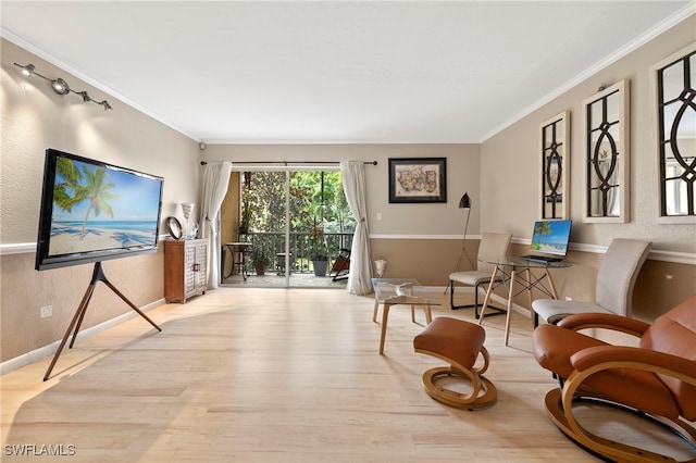 sitting room with light hardwood / wood-style floors and ornamental molding