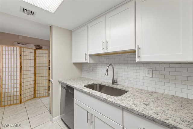 kitchen with tasteful backsplash, visible vents, white cabinets, stainless steel dishwasher, and a sink