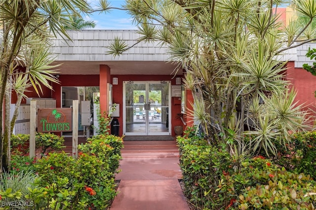 property entrance featuring french doors and stucco siding