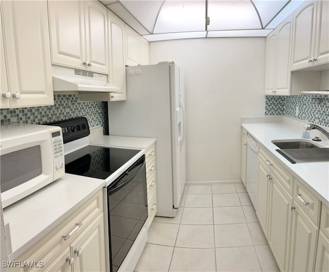 kitchen featuring sink, white appliances, light tile patterned floors, and tasteful backsplash