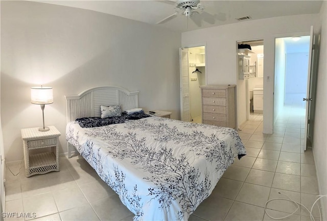 bedroom with a closet, visible vents, and light tile patterned floors