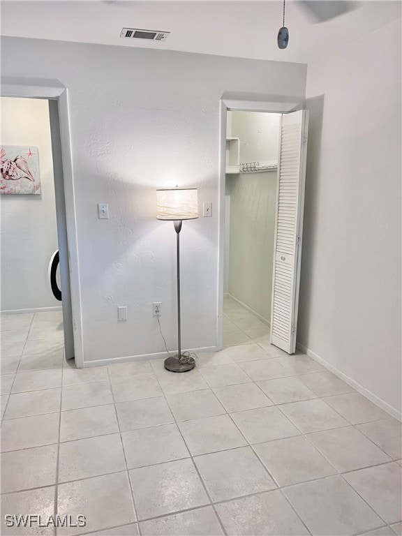 unfurnished bedroom featuring light tile patterned floors