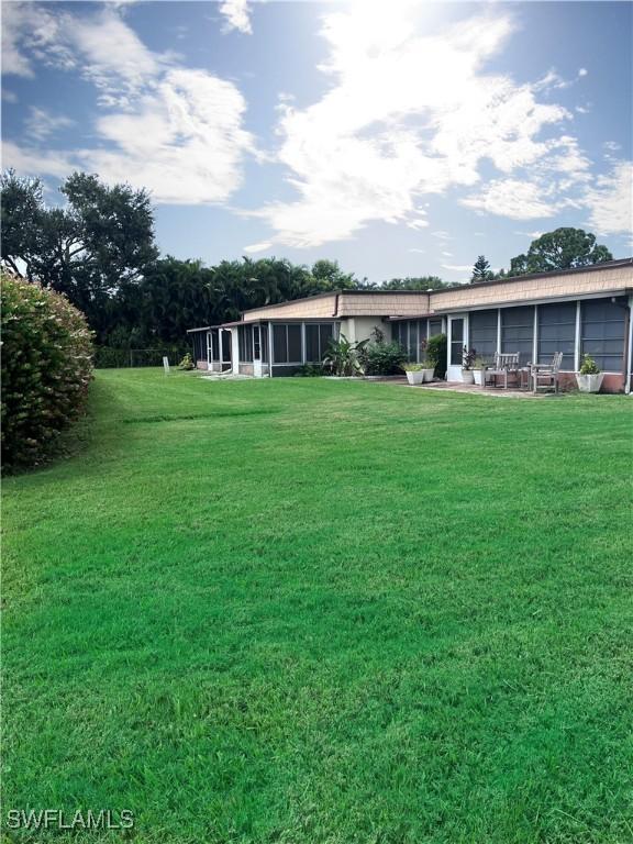 view of yard featuring a sunroom