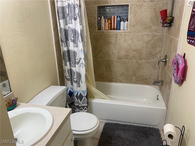 full bathroom with vanity, shower / bath combo, and toilet