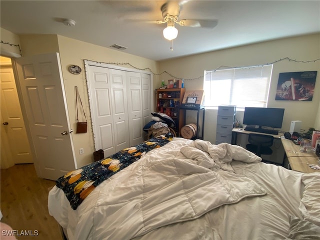 bedroom featuring hardwood / wood-style floors, a closet, and ceiling fan