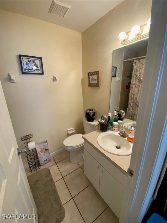 bathroom with vanity, toilet, and tile patterned floors