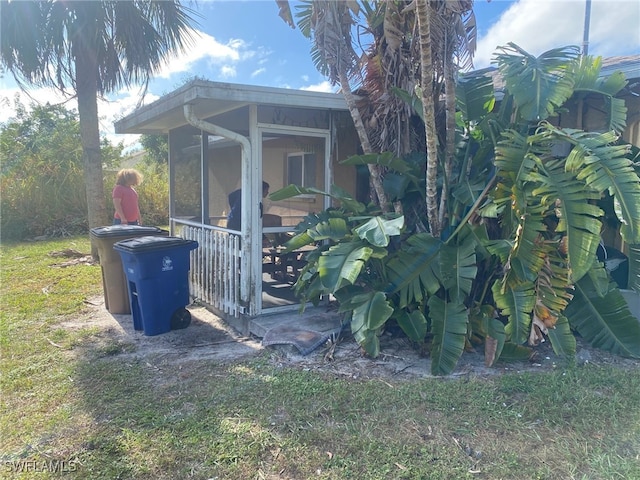 view of outdoor structure with a sunroom