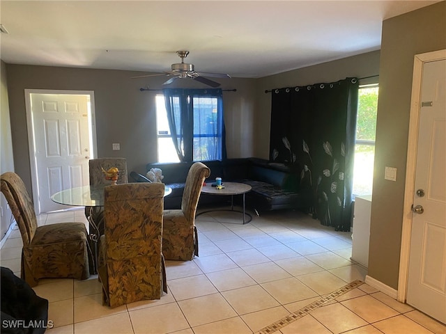 tiled dining room with ceiling fan and a healthy amount of sunlight