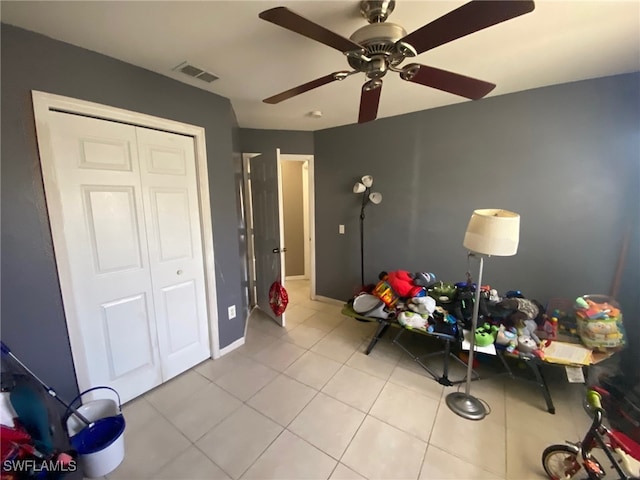 playroom featuring ceiling fan and light tile patterned floors