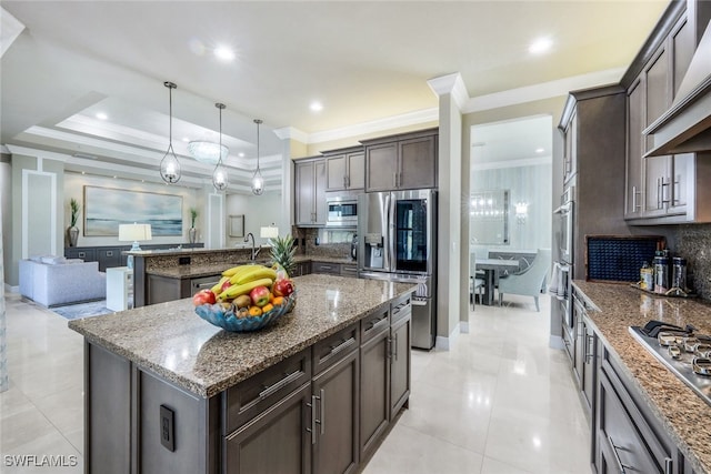 4450 Caldera Cir, Naples, FL 34119 - kitchen featuring stainless steel appliances, decorative backsplash, dark brown cabinets, a peninsula, and ornamental molding