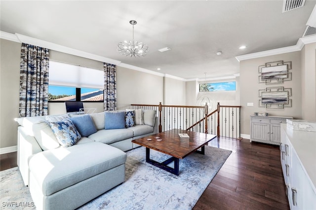 living room featuring dark hardwood / wood-style floors, crown molding, and a chandelier