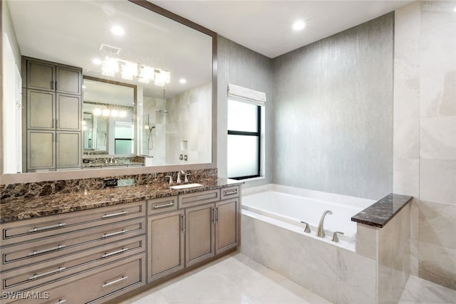 bathroom featuring tile patterned floors, vanity, and separate shower and tub