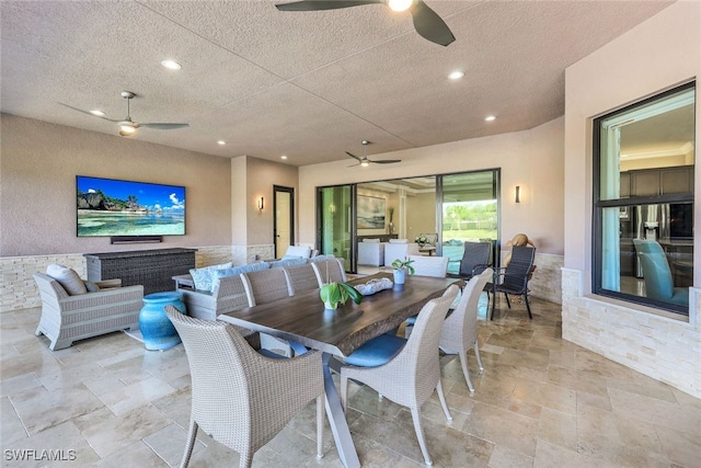 dining area featuring a textured ceiling and ceiling fan