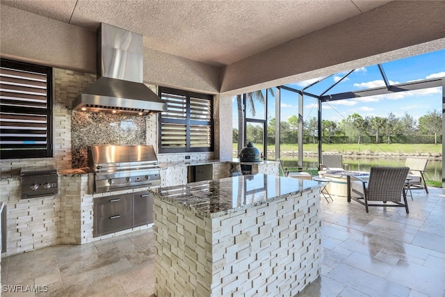 view of patio / terrace featuring an outdoor kitchen, a lanai, and a grill