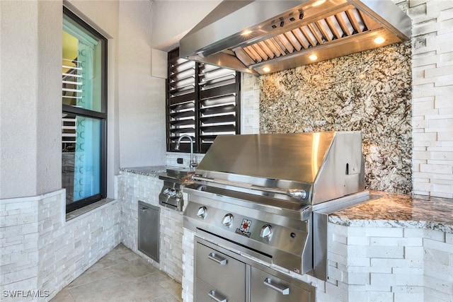 view of patio with a grill, sink, and an outdoor kitchen