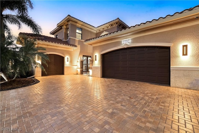 mediterranean / spanish home featuring a garage